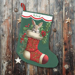 Cute Bunny Rabbit Peeking Large Christmas Stocking<br><div class="desc">This Holiday stocking has an image of an adorable baby bunny rabbit peeking out of an ornate red stocking. The image is surrounded by holly, red berries, and poinsettia blooms, and is placed on a Christmas green background. A white scalloped edge design bordered in red holds your customized name at...</div>