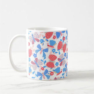 Cute butterfly in a flower garden in red and blue coffee mug