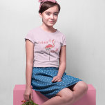 Cute Christmas Pink Flamingo Custom T-Shirt<br><div class="desc">Bring festive cheer to the holidays with our Girls Christmas Shirt, featuring a cute beach coastal design that’s perfect for tropical holiday vibes. Adorned with a tropical pink flamingo and holiday string lights, this shirt combines a stylish calligraphy script with a "Merry and Bright" quote for a charming seasonal touch....</div>