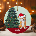 Cute Corgi Santa Hat Monogrammed Christmas Tree Ceramic Ornament<br><div class="desc">This beautiful Pembroke Welsh Corgi dog has a cute Santa Claus hat and an adorable head tilt. The tricolor pup is sitting in front of a pretty Christmas tree decorated with colorful ornaments. Personalize your pet's name in lovely cursive under the wonderful drawing of my favorite doggy.</div>