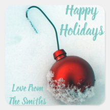 Cute festive red ornament on snow holiday photo