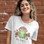 Cute Frog and Mushrooms Be Hoppy Cartoon  T-Shirt<br><div class="desc">This cute T-shirt features a hand-drawn kawaii style cartoon frog, wearing a mushroom hat, along with other mushrooms, a snail, a flower, a butterfly, and grass. A colour scheme of red, lime, green, brown, orange, yellow, and peach is perfect for either the Indie or Cottage Core Aesthetic lover. Customize the...</div>