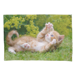 Cute funny cat kitten playing in a flowery garden pillowcase