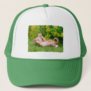 Cute funny cat kitten playing in a flowery garden trucker hat