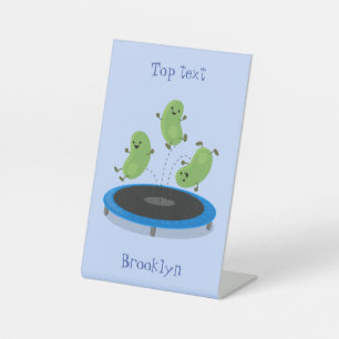 Cute funny green beans on trampoline cartoon pedestal sign