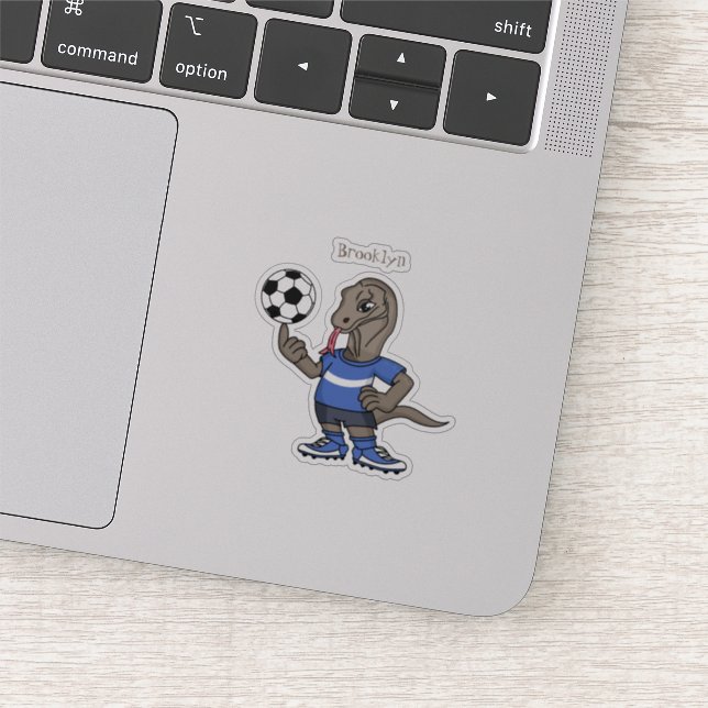Cute funny Komodo dragon playing soccer cartoon (Detail)
