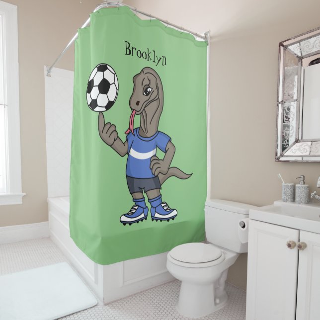 Cute funny Komodo dragon playing soccer cartoon (In Situ)