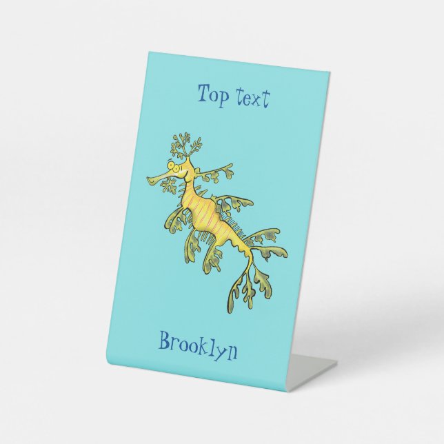 Cute funny leafy sea dragon cartoon illustration pedestal sign (Front)