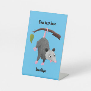 Cute funny opossum hanging from branch cartoon pedestal sign