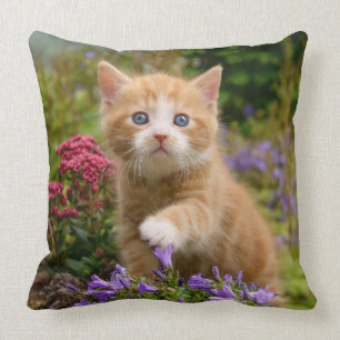 Cute ginger kitten in a garden throw pillow