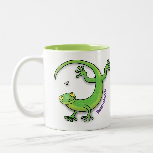 Cute happy green gecko lizard with bug cartoon Two-Tone coffee mug (Left)