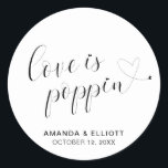 Cute Heart Popcorn Favours Modern Wedding Classic Round Sticker<br><div class="desc">Typography wedding favour stickers featuring the message, "Love Is Poppin" in black calligraphy with a heart dotting the "i's" and a swash at the end and your names and date below, over a white background. The simple and minimal layout and lots of open space give this design a modern feel...</div>
