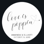 Cute Heart Popcorn Favours Modern Wedding Classic Round Sticker<br><div class="desc">Typography wedding favour stickers featuring the message, "Love Is Poppin" in black calligraphy with a heart dotting the "i's" and a swash at the end and your names and date below, over a white background. The simple and minimal layout and lots of open space give this design a modern feel...</div>