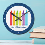 Cute Kindergarten Teacher Custom Crayon Classroom Round Clock<br><div class="desc">A beautiful Teacher Appreciation Week or End of Year gift for a kindergarten class to give to their elementary school teacher. Custom made clock with their name customized in blue. Personalize with your name or text under the cute rainbow of crayons. An adorable present for a preschool teacher.</div>