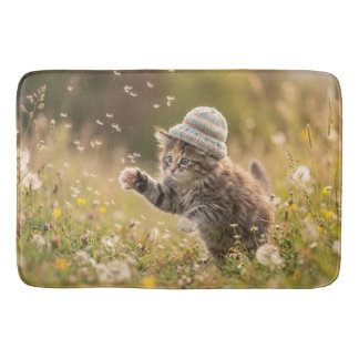 Cute Kitten Wearing a Hat Playing with Dandelions Bath Mat