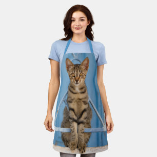 Cute Nosy Tabby Cat Kitten Sitting in a Blue Fence Apron