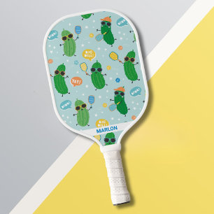 Cute Pickles playing Pickleball on light blue Paddle