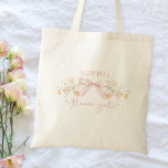 Cute Pink Bow and Wildflowers Modern Flower Girl Tote Bag<br><div class="desc">Make your flower girl feel extra special with this charming personalized t-shirt! Featuring a delicate floral design and a sweet bow, this shirt is perfect for adding a touch of elegance to your wedding party. Customize it with her name to create a keepsake she'll cherish forever. Crafted from soft, comfortable...</div>