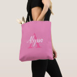 Cute Pink White Script Monogram Tote Bag<br><div class="desc">Cute Pink White Script Monogram Tote Bag featuring an elegant arrangement of name (in white) and monogram initial (in hot pink) on a pretty pink background. The bag is easy to personalize by typing the name and initial of your choice into the online personalization template before ordering. The text automatically...</div>
