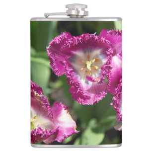 Cute purple tulips in the garden hip flask