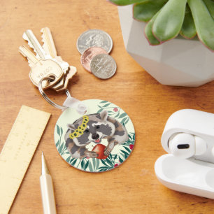 Cute raccoon with an apple in the paws keychain