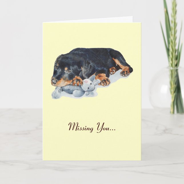 cute rottweiler puppy cuddling teddy missing you card (Front)