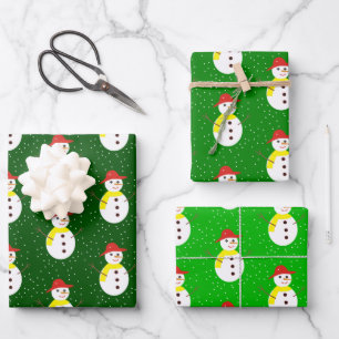 Cute snowman and snow on green wrapping paper sheet