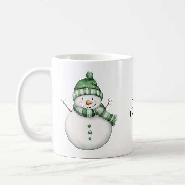 Cute Snowman in Green Scarf and Knit Beanie Coffee Mug (Left)