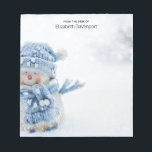 Cute Snowman in Winter Photograph Christmas Notepad<br><div class="desc">A notepad with a cute photograph of a little snowman. Standing outside in the winter with snow falling all around. This cute little guy is dressed up in blue knitted hat and scarf. Some white/grey bokeh flare in the background.</div>