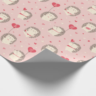 Cute valentine's hedgehogs with hearts on pink wrapping paper
