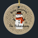 Cute Winter Christmas Snowman Ceramic Ornament<br><div class="desc">A cute Christmas snowman with the words Merry Christmas decorates this ornament. Personalize it with your family name. A fun accent for the Christmas holiday season. Designed for you by Blackberry Boulevard.</div>