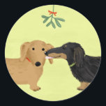 Dachshunds Mistletoe Kiss | Christmas Wiener Dogs Classic Round Sticker<br><div class="desc">A cute Dachshund lover’s Christmas sticker,  great for sealing gifts this holiday season. Black and tan longhaired Doxie and red shorthaired Dachshund kiss under the mistletoe. An original cartoon weenie dogs art illustration by ©Jenn Inashvili. Visit Jenn’s Doodle World for some original gifts featuring this adorable dogs design.</div>