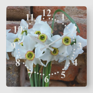 daffodils near fortress wall square wall clock