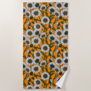 Daisies on orange beach towel