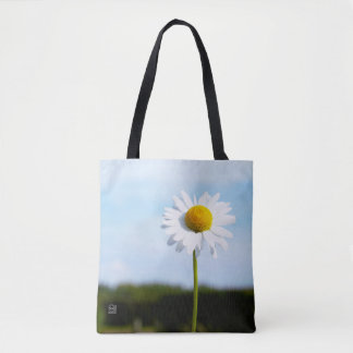 Daisy standing upright in nature. tote bag