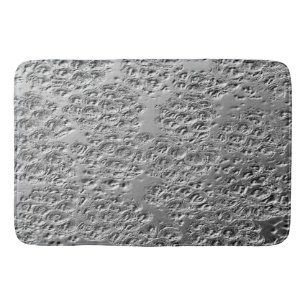 Damaged silver metal bath mat