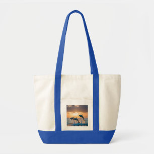 Dancing in the Dusk: Three Dolphins Leaping Tote Bag