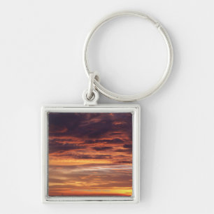 Dark clouds in orange streaked sky keychain