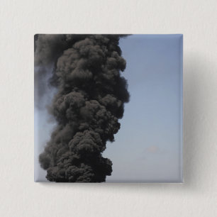 Dark clouds of smoke and fire emerge 2 inch square button