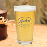Dark Grey Stylized Wedding Groomsman Name Glass<br><div class="desc">Beer glass for the wedding groomsman that features his name printed in a dark grey, stylized script inside a dark grey bordered oval along with wedding date. A great party supply idea for a bachelor party! Personalize your beer glass by editing and replacing name and date with your own. Available...</div>