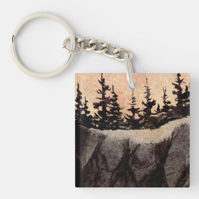 Dark pines on sheer cliff with greyed pink sky art keychain (Front)