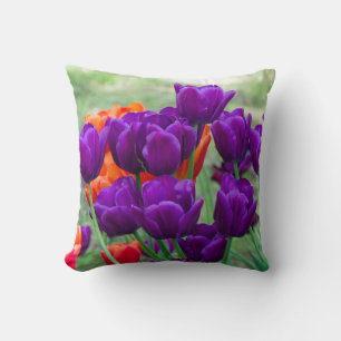 Dark purple tulips on a sunny day in the garden throw pillow