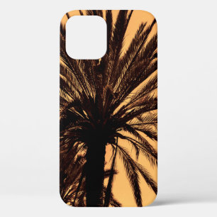 Dark silhouettes of date palms against bright colo iPhone 12 case