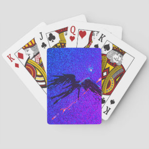 Dark winged figure flying across the space playing cards