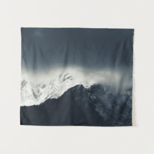 Darkness and light on snow covered mountains tapestry