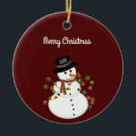 Dated Merry Christmas Snowman Personalized Ceramic Ornament<br><div class="desc">Cute snowman is tangled with lit Christmas lights, has the year on his hat - The "Merry Christmas" text above can be changed or added to, and the font style/size can also be changed. Shown on a deep red background, which can be changed to any colour you prefer. The ornament...</div>