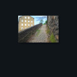 Dean Clough Cobblestone Climb - Brandt's Spirit  Canvas Print<br><div class="desc">Ascend a charming, overgrown cobblestone path in Dean Clough, Halifax, where historic industrial architecture meets the subtle vibrancy of nature. This image, while inspired by the evocative work of Bill Brandt, brings a fresh perspective with its natural colors, highlighting the subtle greens of the moss and the warm tones of...</div>