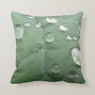 Decocased drop of water on green throw pillow