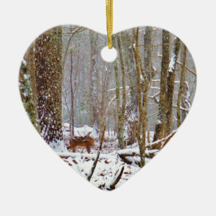 Deer in the snow, licking leg ceramic ornament