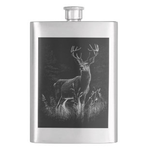 Deer with antlers framed by field and tree hip flask